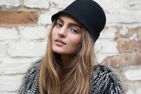 Portrait of the beautiful fashionable girl in trendy hat