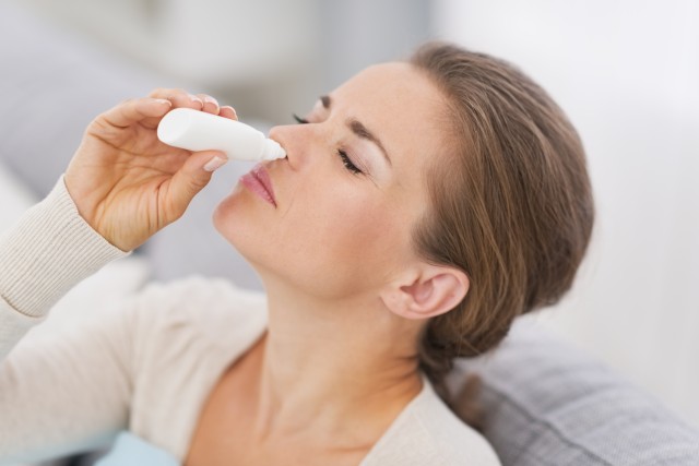 woman using nasal drops